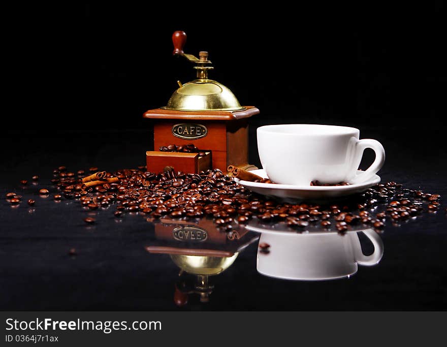 Coffee Mill On The Table With Coffee Beans Around