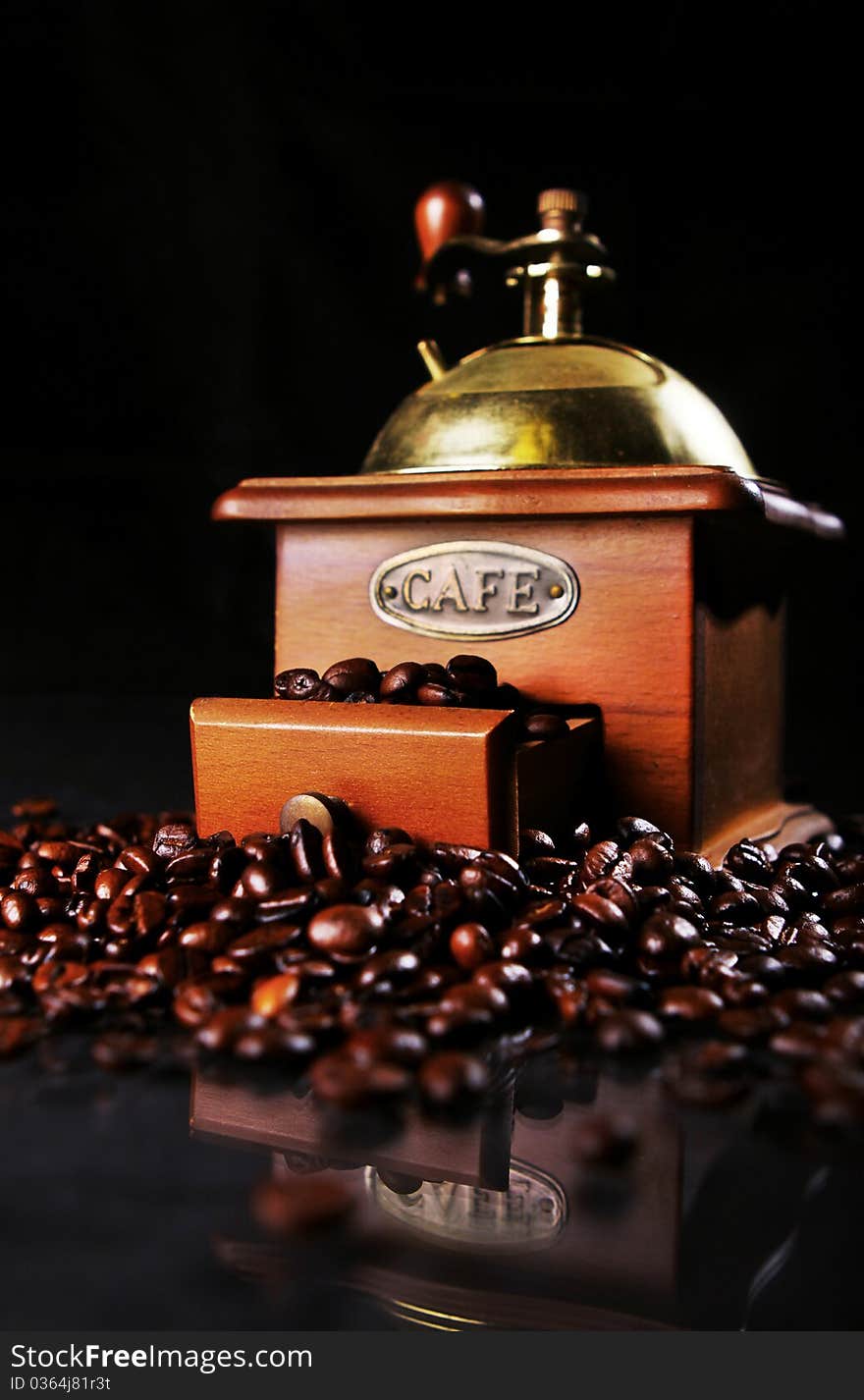 Coffee Mill On The Table With Coffee Beans Around