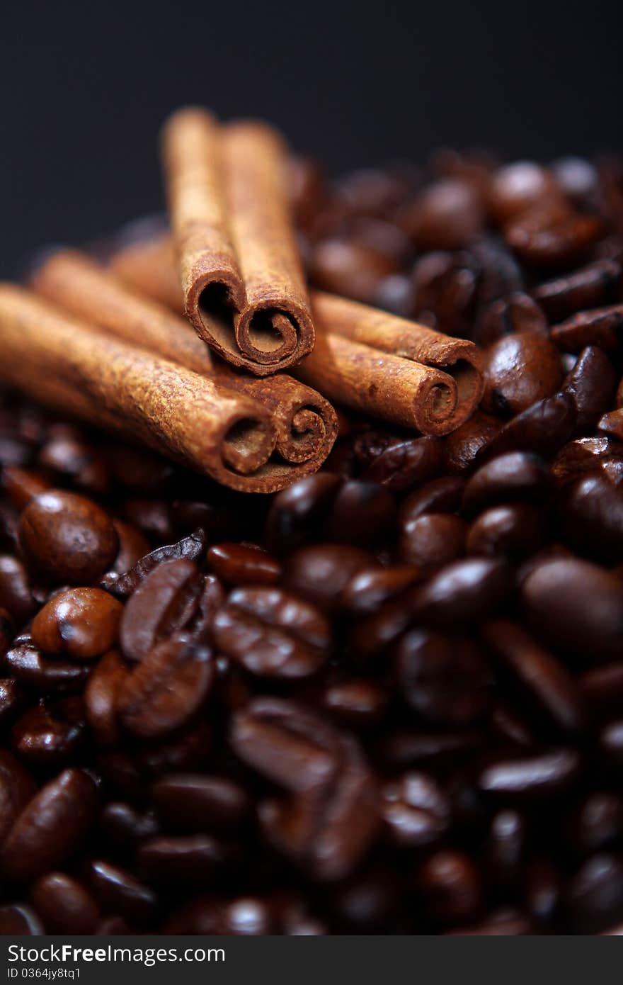 Coffee beans and canella sticks close up. Coffee beans and canella sticks close up