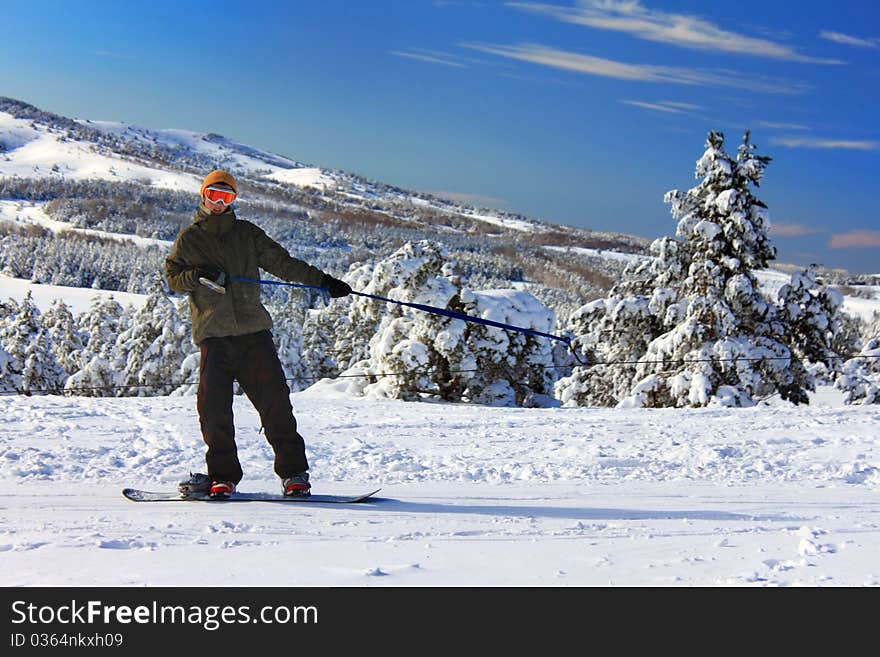 Snowboarder on the slope rises up