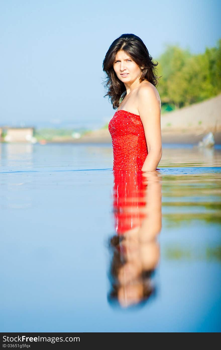 Girl dressed in red dress on a coast. Girl dressed in red dress on a coast