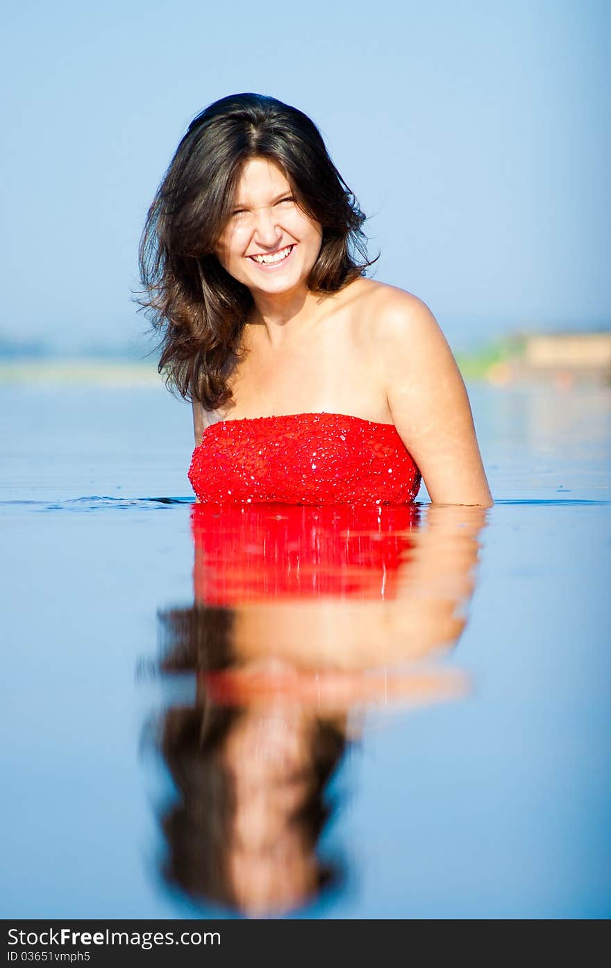 Girl dressed in red dress on a coast. Girl dressed in red dress on a coast