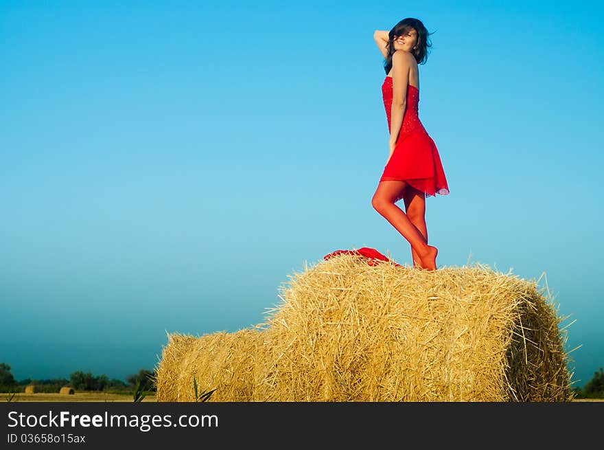 Woman on landckape near haystack