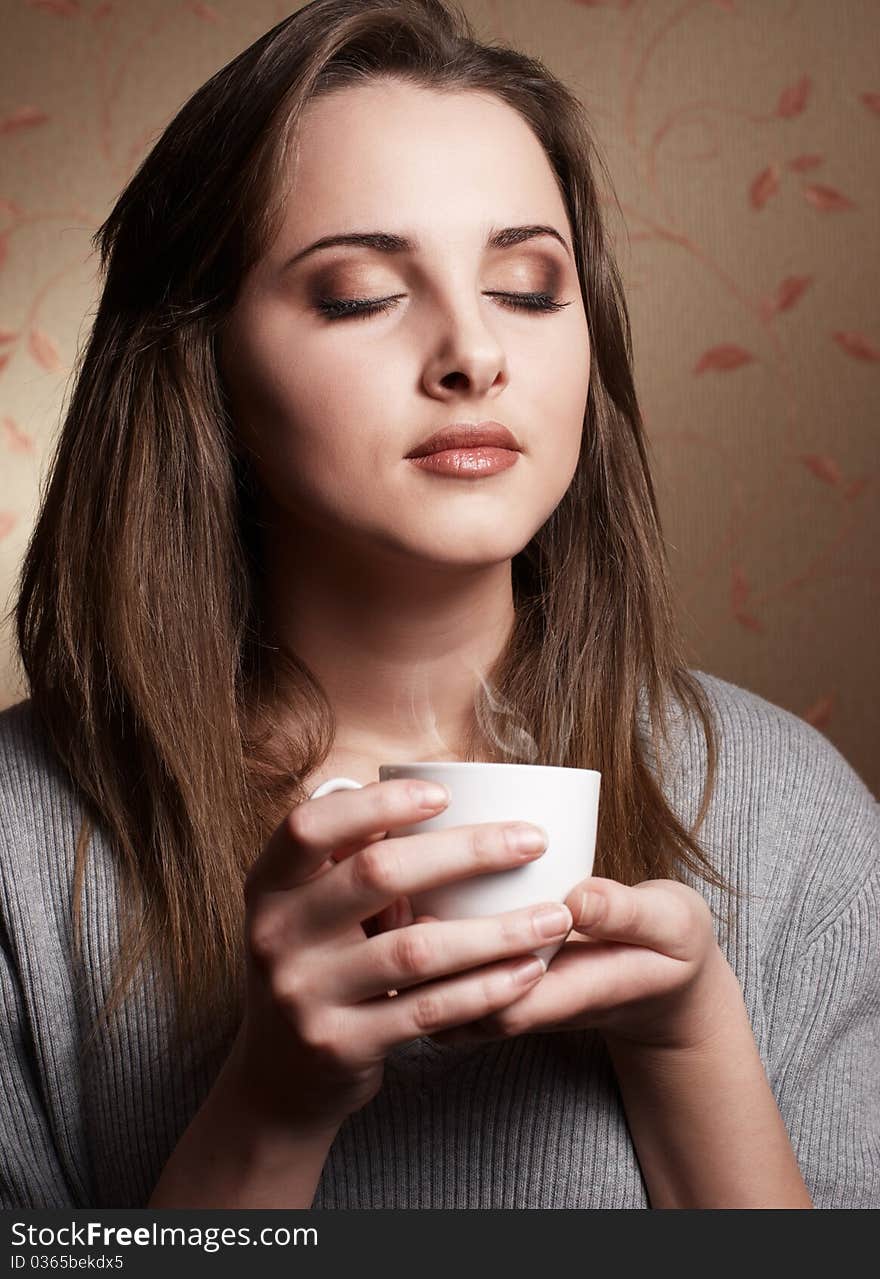 Beautiful young woman with cup of coffee