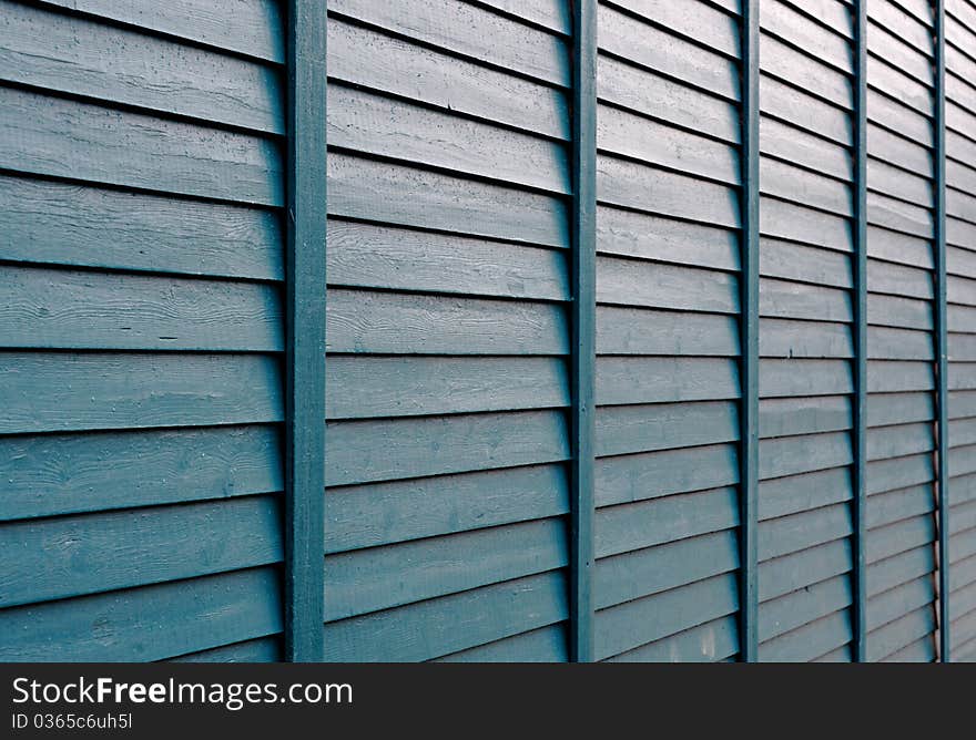 The green boards in lines. A facade or wall of an wood house. The green boards in lines. A facade or wall of an wood house.