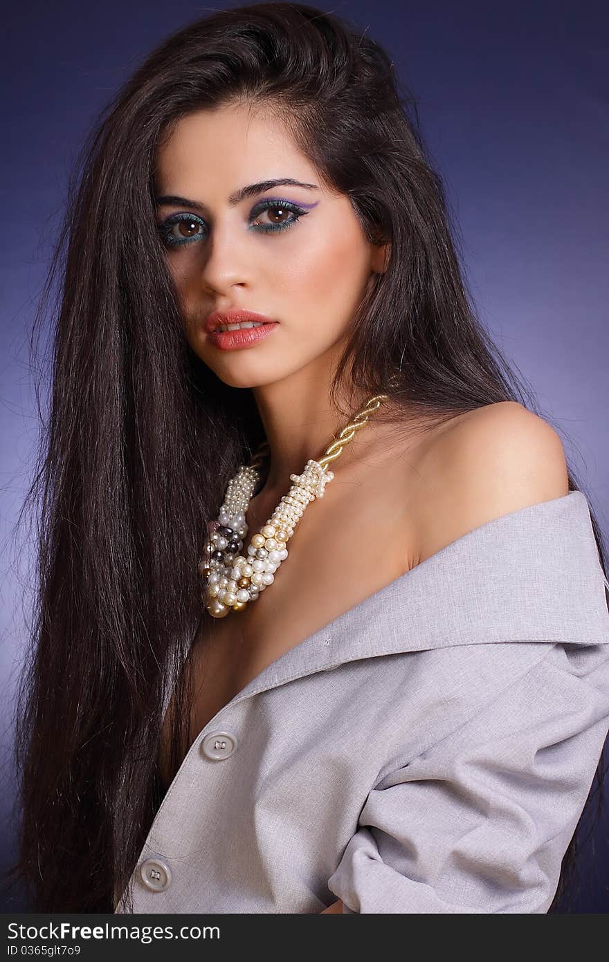 Studio photo of woman whearing a pearl necklace. Studio photo of woman whearing a pearl necklace