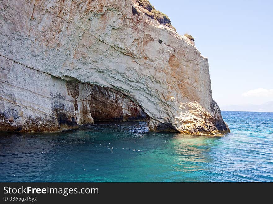 Rocky cliff surrounded by blue ocean