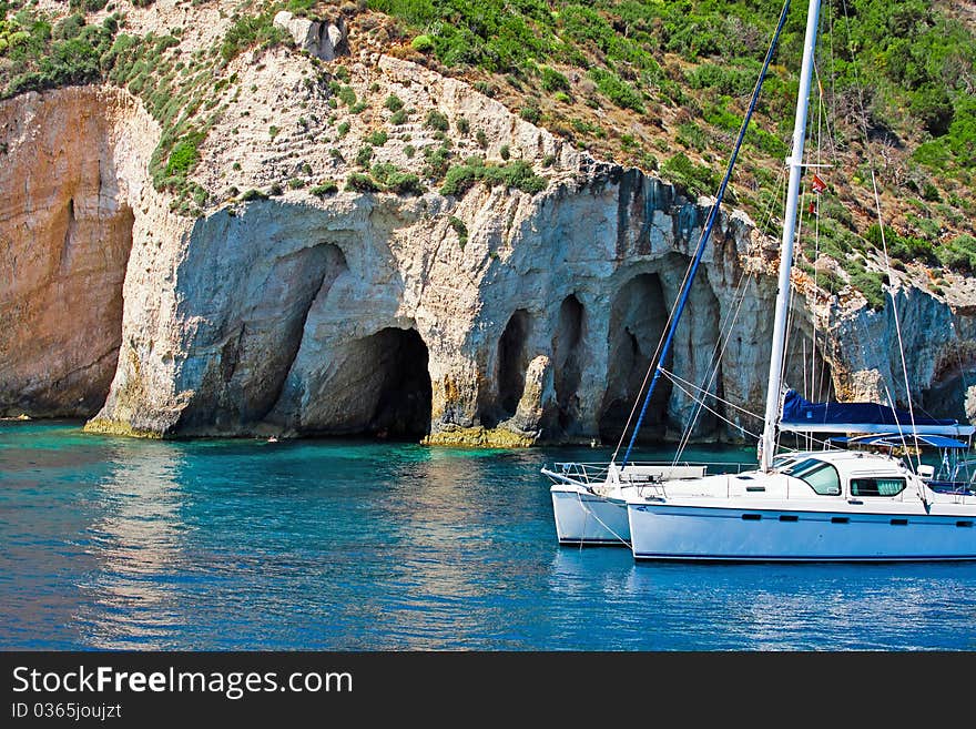 Boat Docked Near Rocky Shore In the Sea