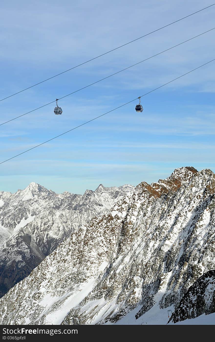 Winter Holiday Gondola Ski Lift Above Alps Mountains