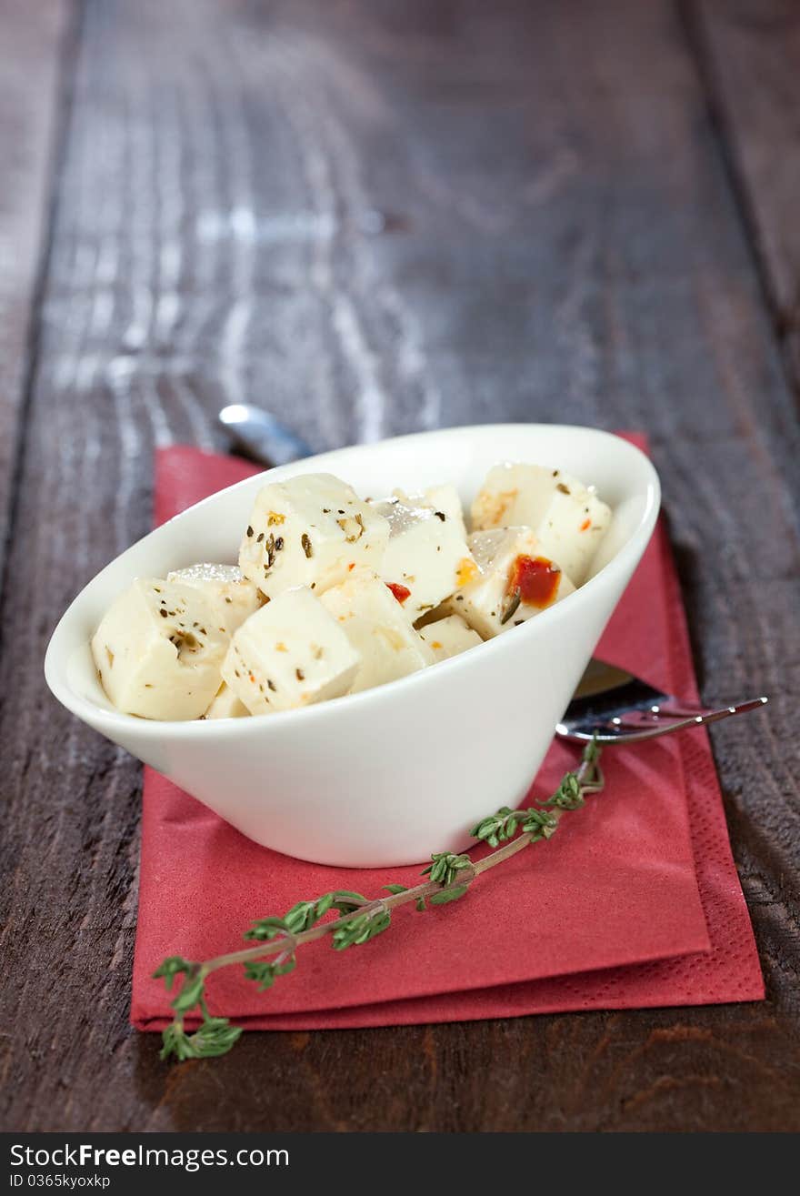 Fresh feta cubes with herbs in a bowl. Fresh feta cubes with herbs in a bowl