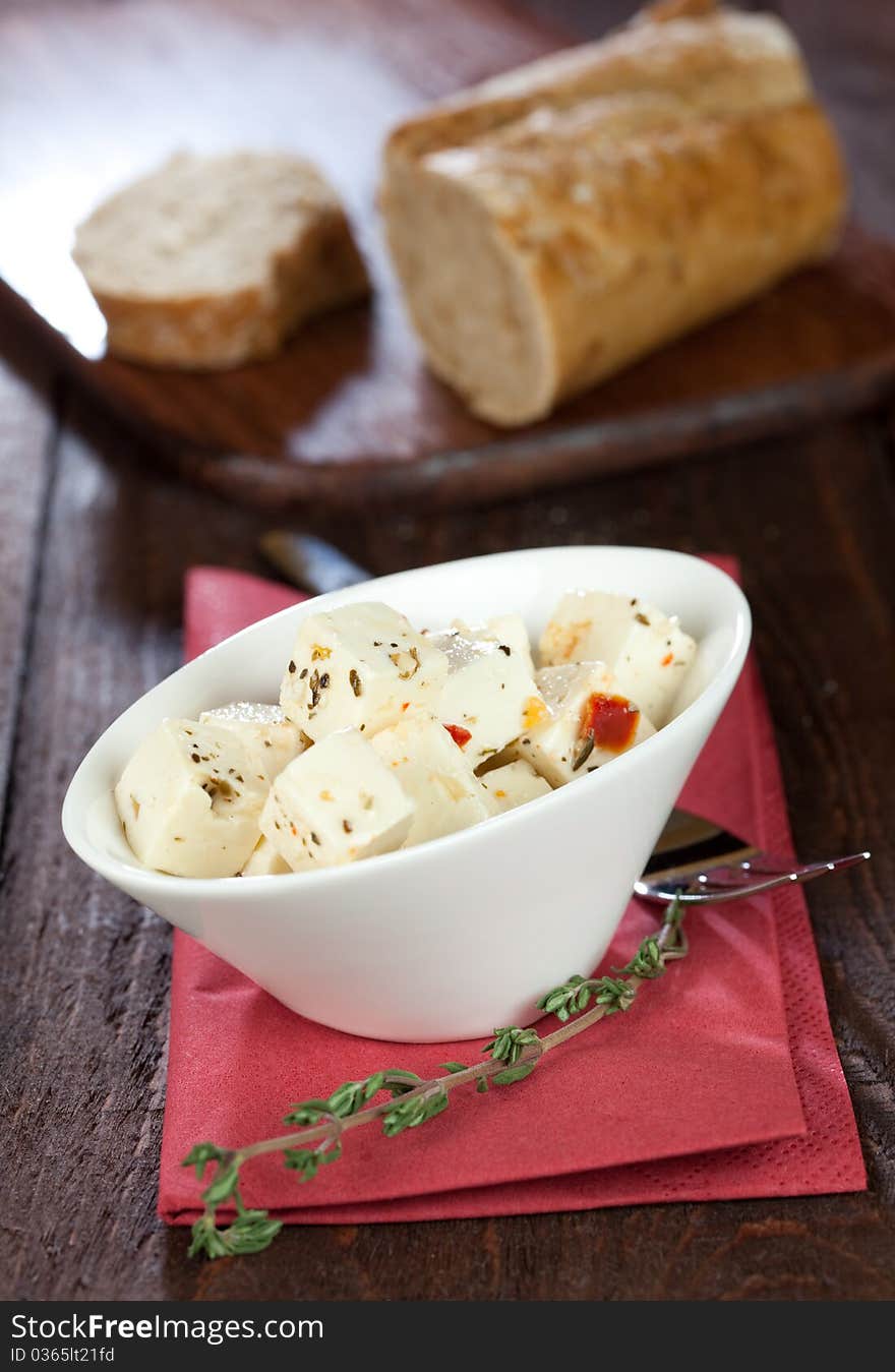 Fresh feta cheese cubes in a bowl with baguette. Fresh feta cheese cubes in a bowl with baguette