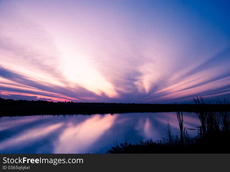 Dramatic sky after sunset reflection