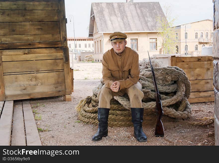 Retro style picture with soldier sitting on rope