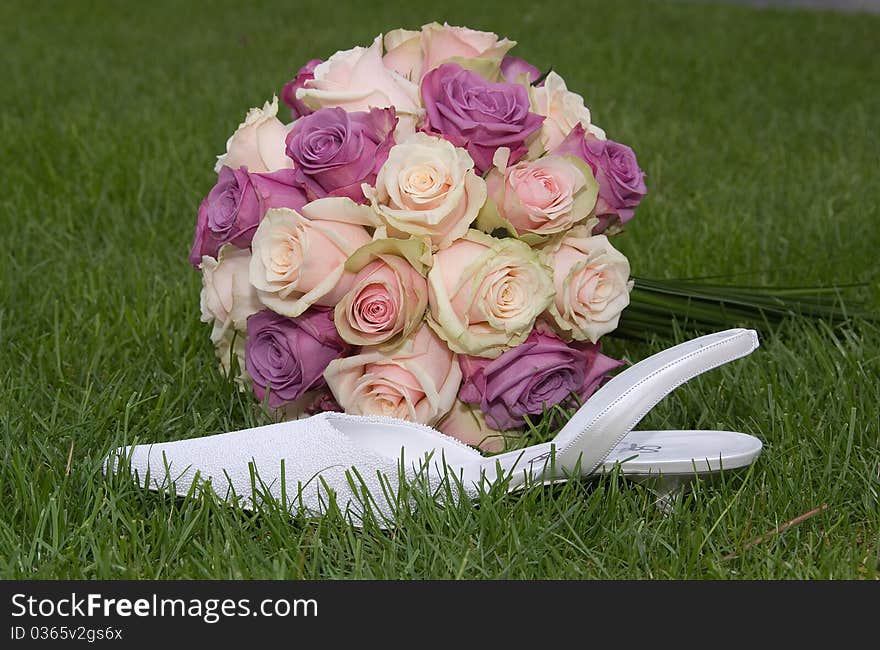 Beautiful bridal bouquet with shoe in thr grass. Beautiful bridal bouquet with shoe in thr grass