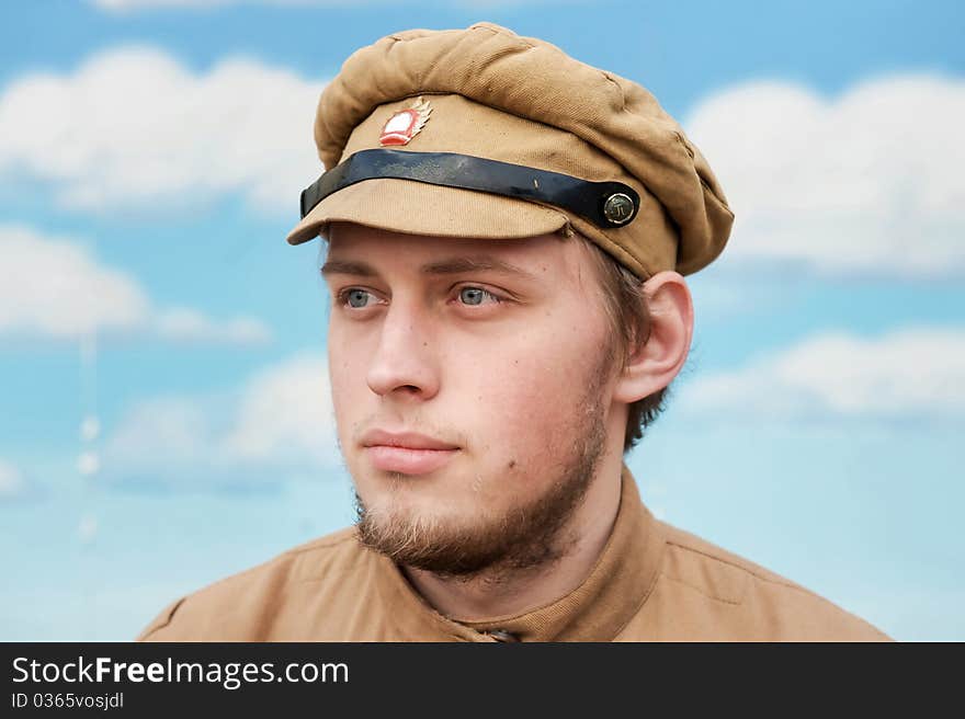 Portrait of soldier in uniform of World War 1 on the background of blue sky. Costume accord the times of World War I. Photo made at cinema city Cinevilla in Latvia. Cockade on the hat do not contain trade mark. Portrait of soldier in uniform of World War 1 on the background of blue sky. Costume accord the times of World War I. Photo made at cinema city Cinevilla in Latvia. Cockade on the hat do not contain trade mark.