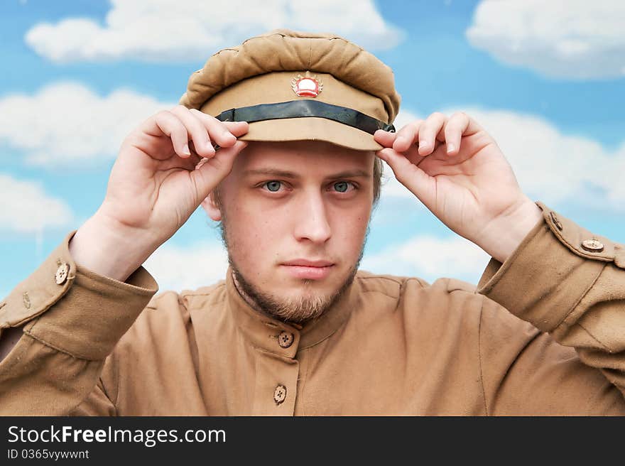 Portrait of soldier in uniform of World War 1 on the background of blue sky. Costume accord the times of World War I. Photo made at cinema city Cinevilla in Latvia. Cockade on the hat do not contain trade mark. Portrait of soldier in uniform of World War 1 on the background of blue sky. Costume accord the times of World War I. Photo made at cinema city Cinevilla in Latvia. Cockade on the hat do not contain trade mark.