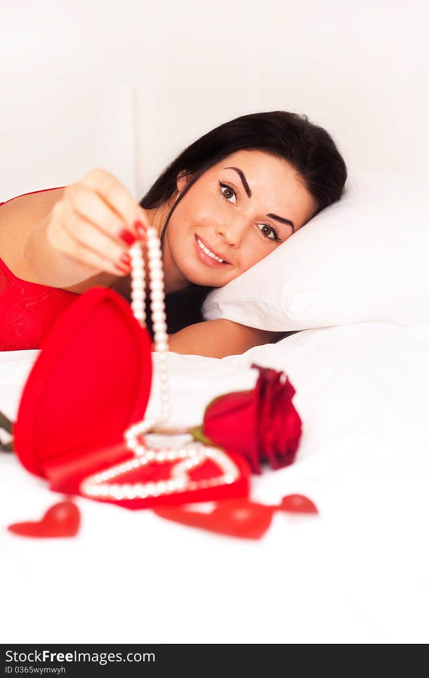 Girl Lying In Bed, Strewn With Hearts And Roses