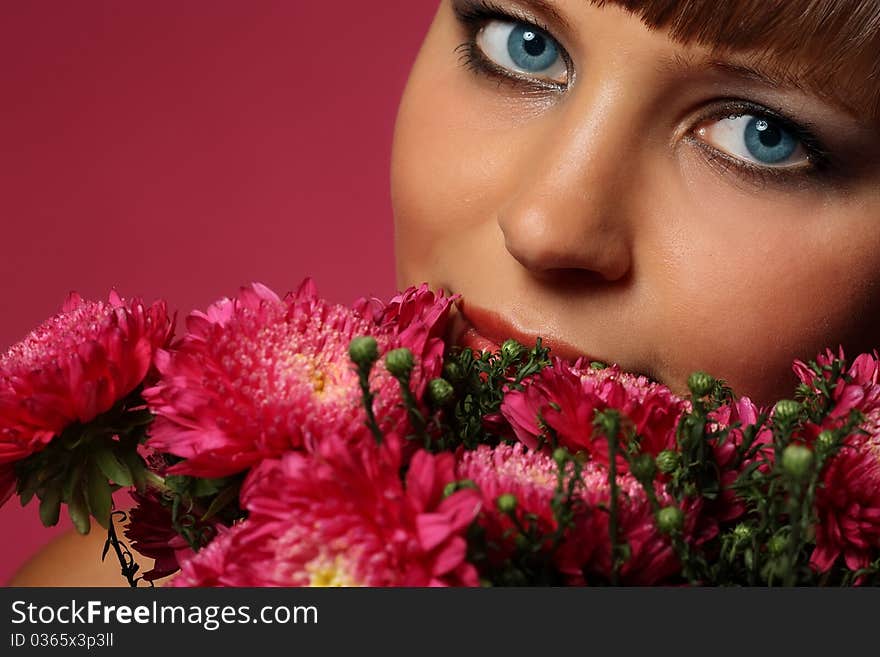 Portrait of a young woman with pink flowers