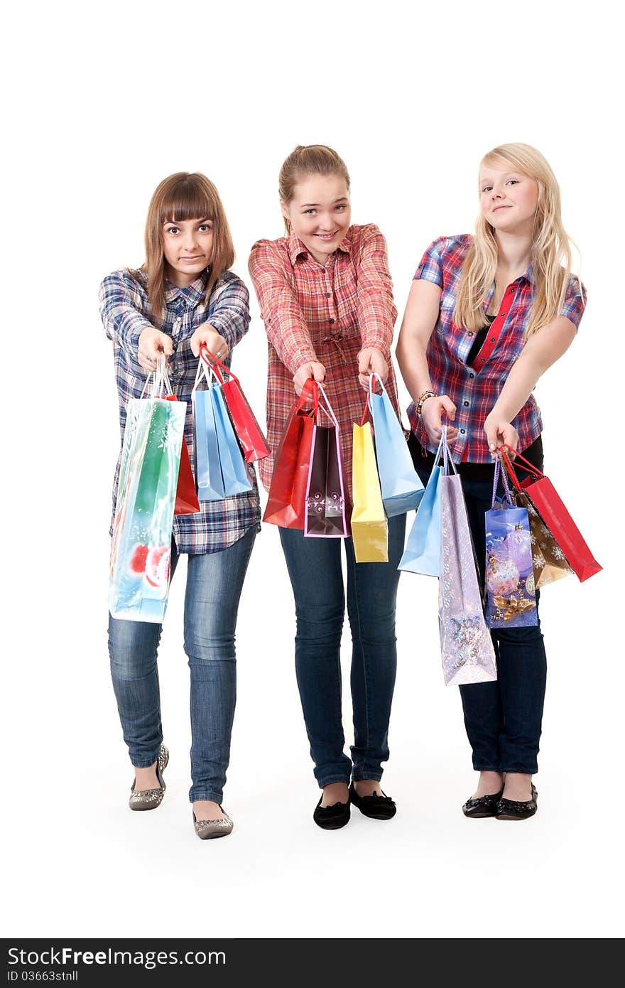 Three girls with colorful shopping bags