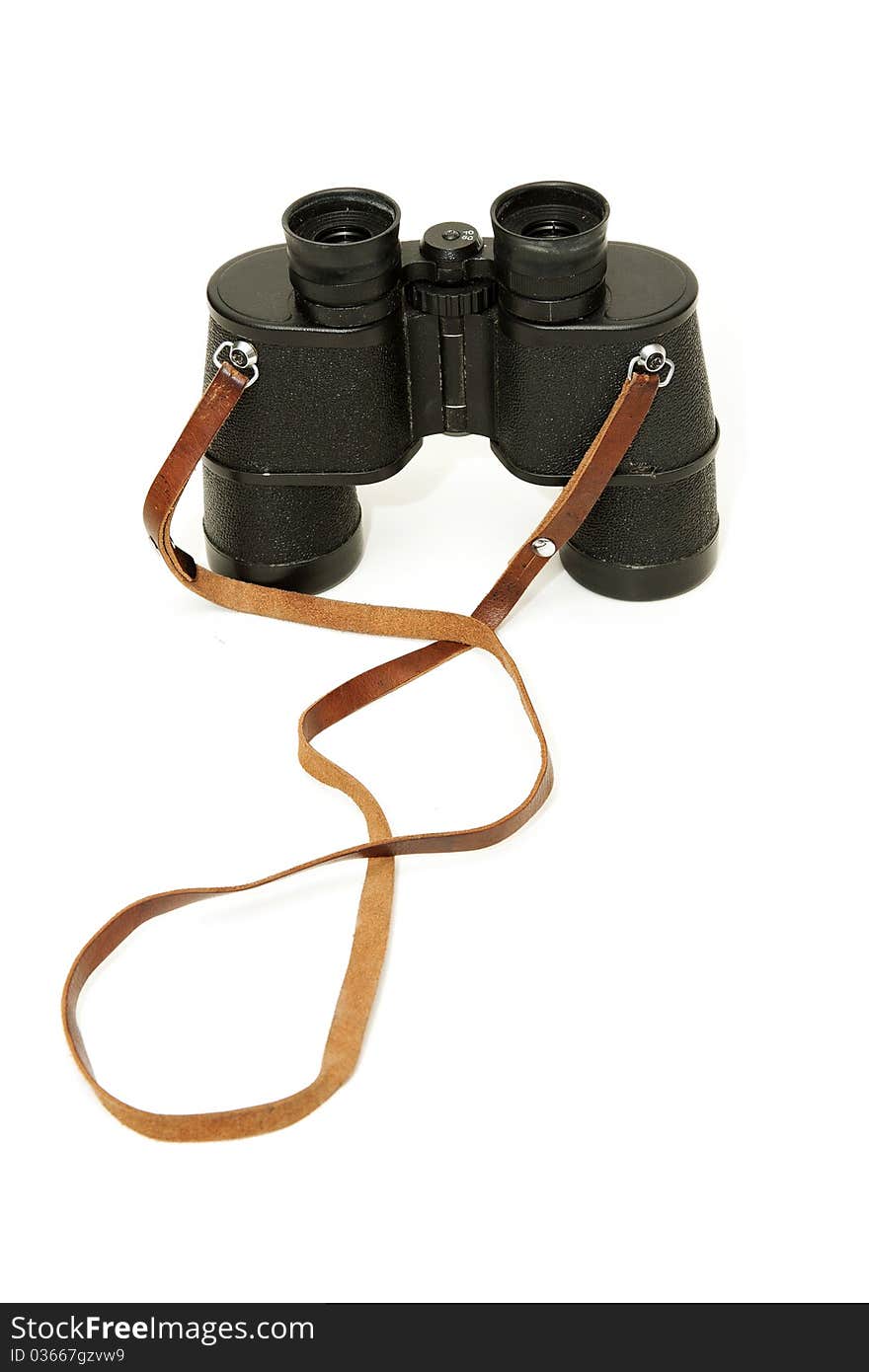 Old black glasses with a leather strap on a white background