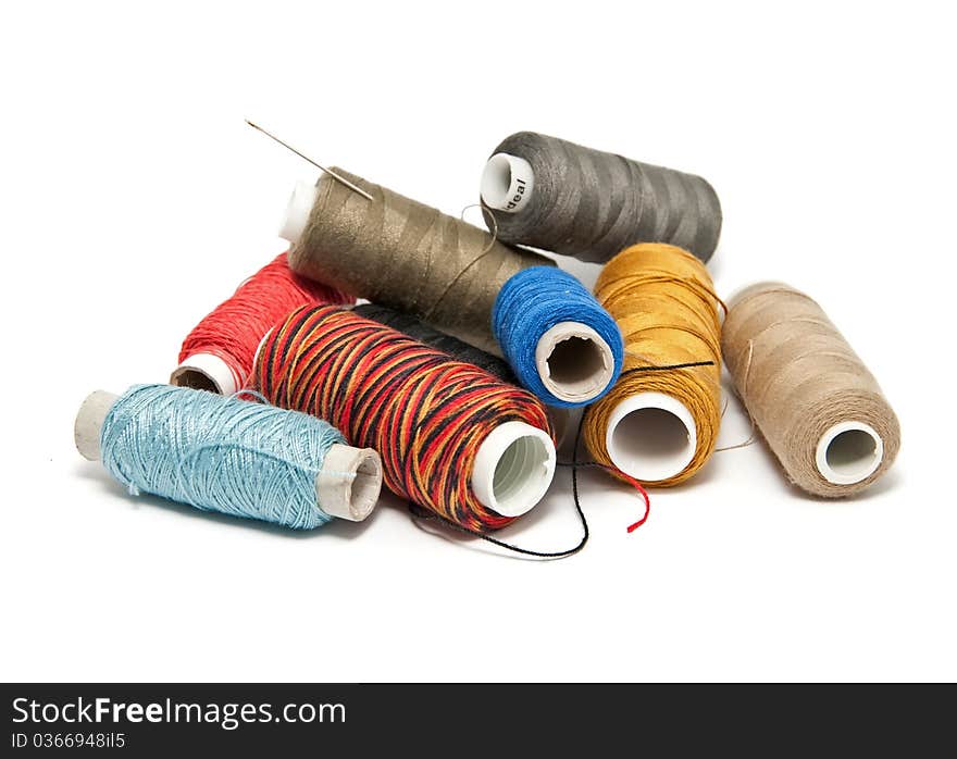 Group colored skeins of thread on white background