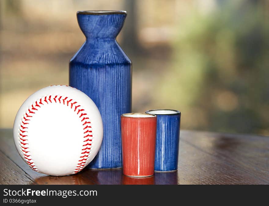 Saki server with two saki glasses and baseball. Saki server with two saki glasses and baseball