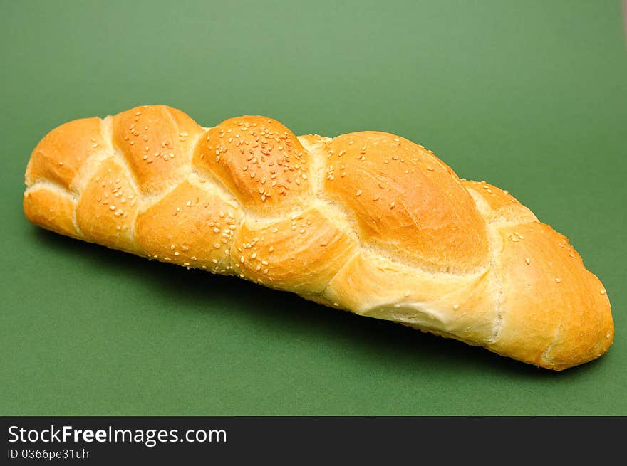 Fresh bread isolated on green background