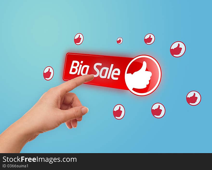 Hand pressing BIG SALE button on blue background