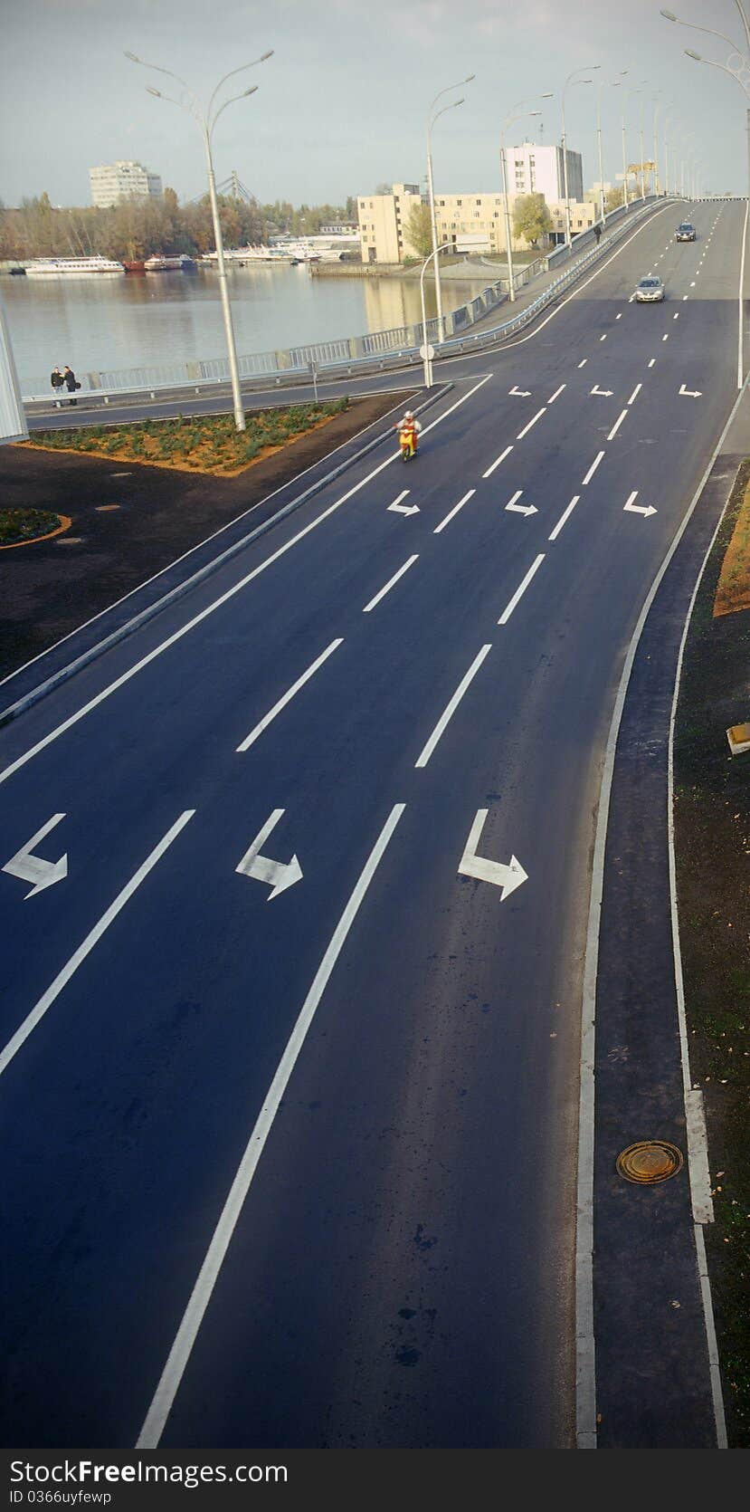 Multiple lane highway with arrow signs painted on asphalt. Multiple lane highway with arrow signs painted on asphalt.