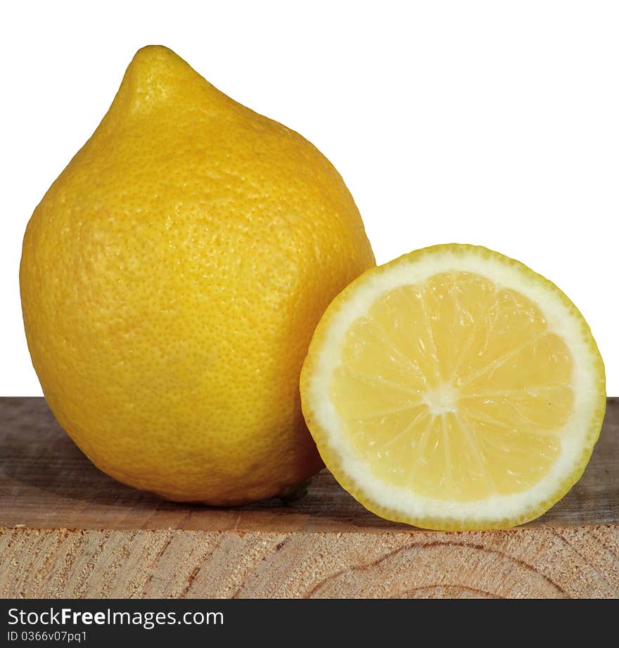 Lemon and the cut off part of a lemon on a background of the cut board. Lemon and the cut off part of a lemon on a background of the cut board