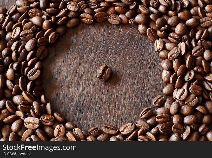 Coffee bean arranged on a wooden table. Coffee bean arranged on a wooden table