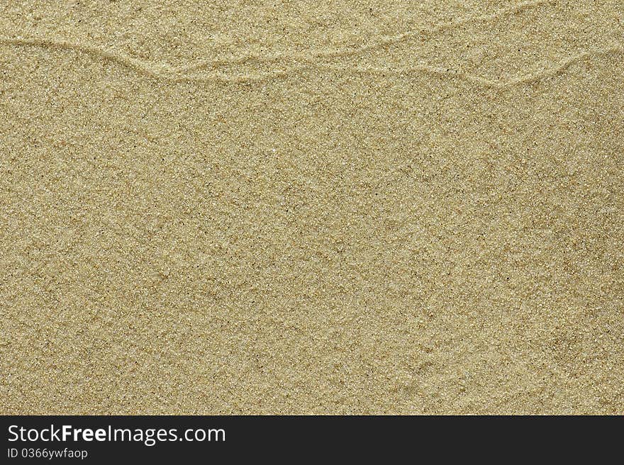 Fine-grained sand with simple watermark texture on top for background. Fine-grained sand with simple watermark texture on top for background