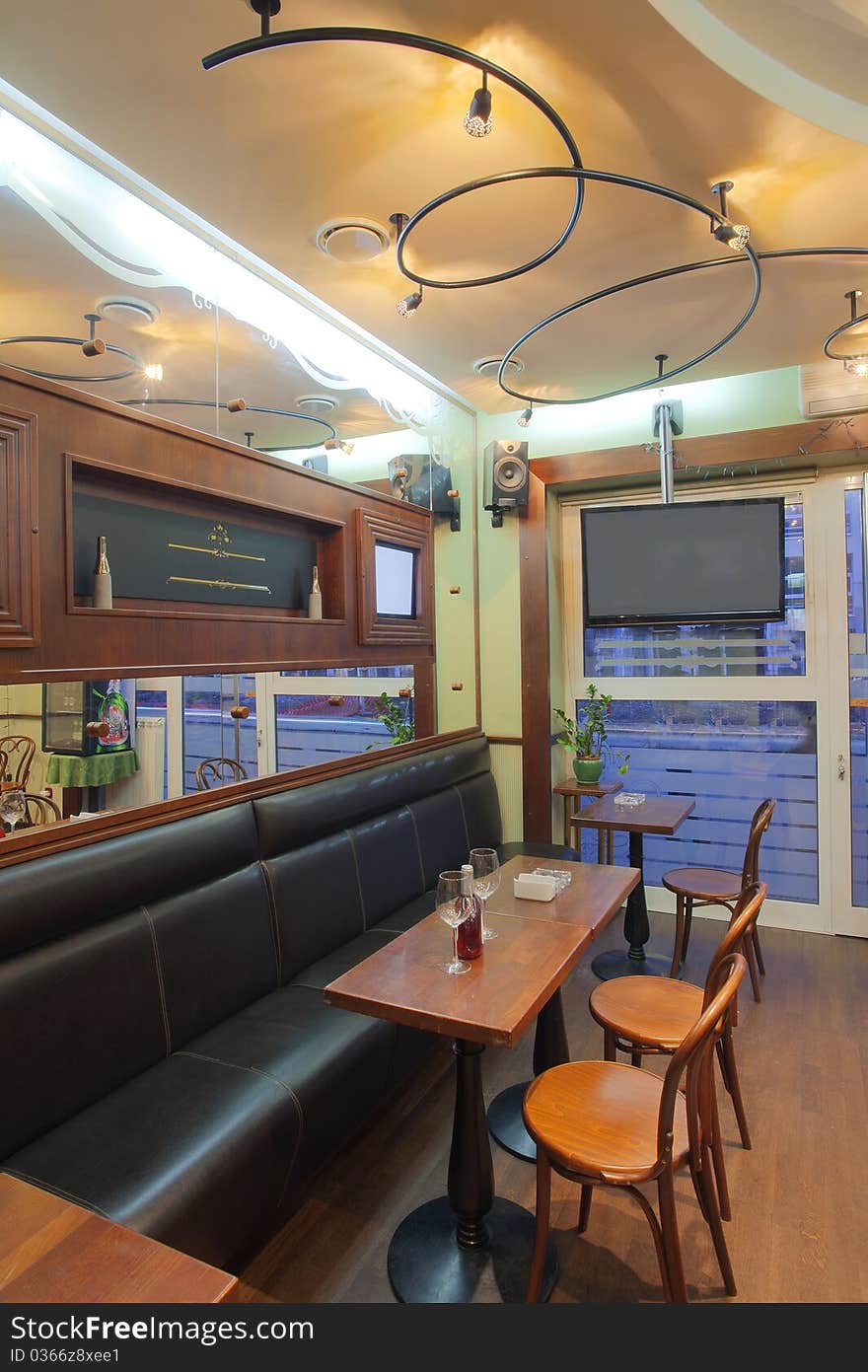 Interior of a small cafe, old fashioned style mixed with modern media equipment. Interior of a small cafe, old fashioned style mixed with modern media equipment.