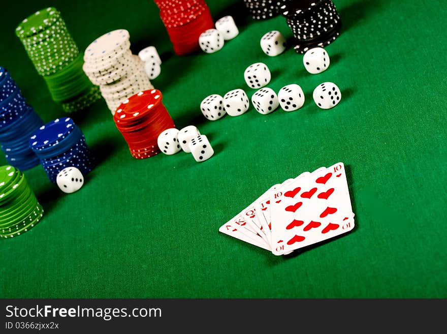 Casino gambling chips and playing cards  on green table. Casino gambling chips and playing cards  on green table