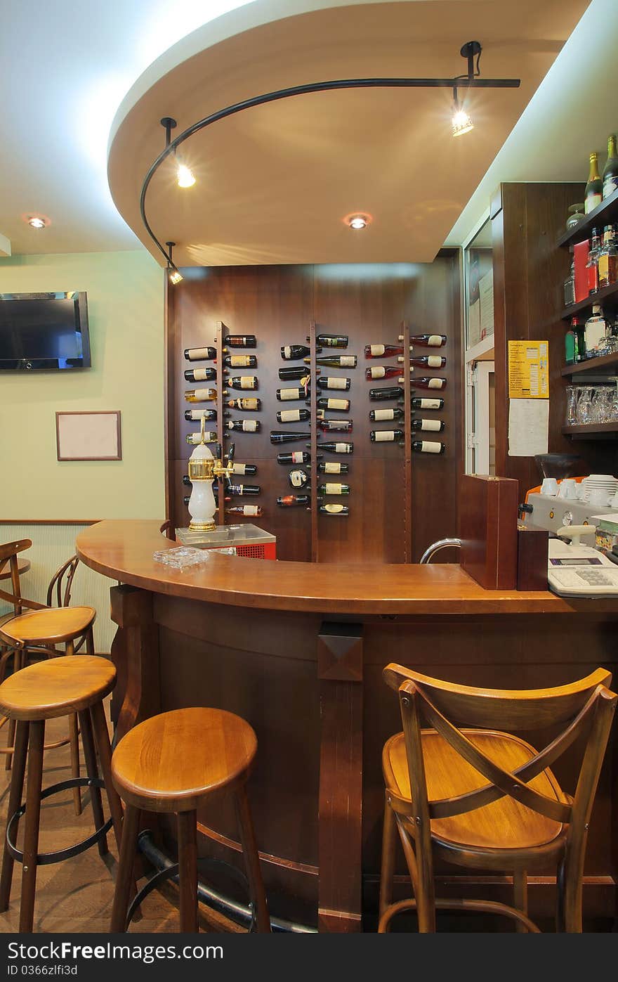 Interior of a small cafe, view on a wooden bar. Interior of a small cafe, view on a wooden bar.