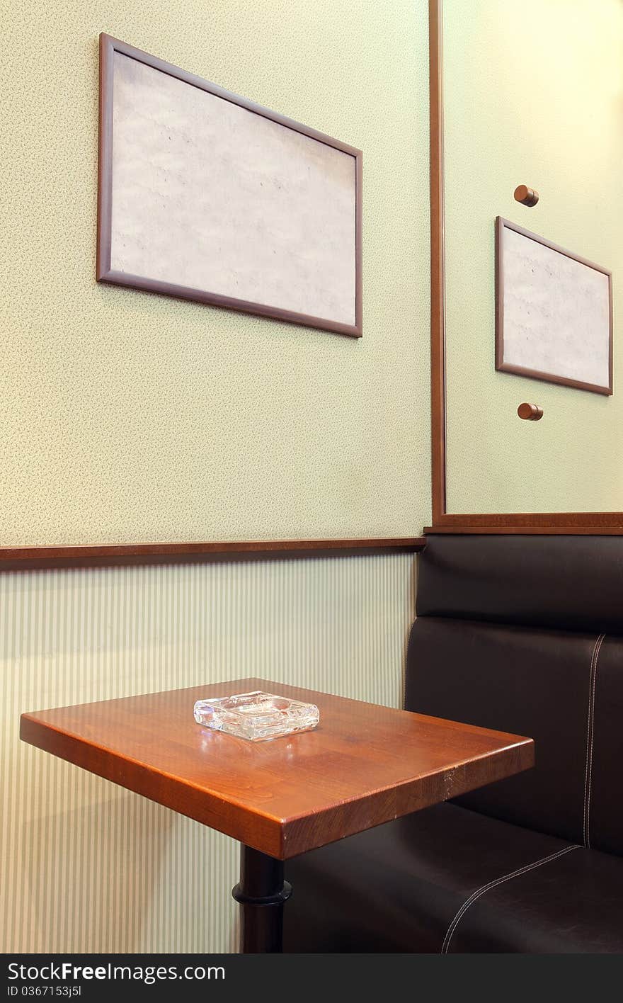 Details of an interior of a small cafe. Just chairs, empty frames and tables. Details of an interior of a small cafe. Just chairs, empty frames and tables.