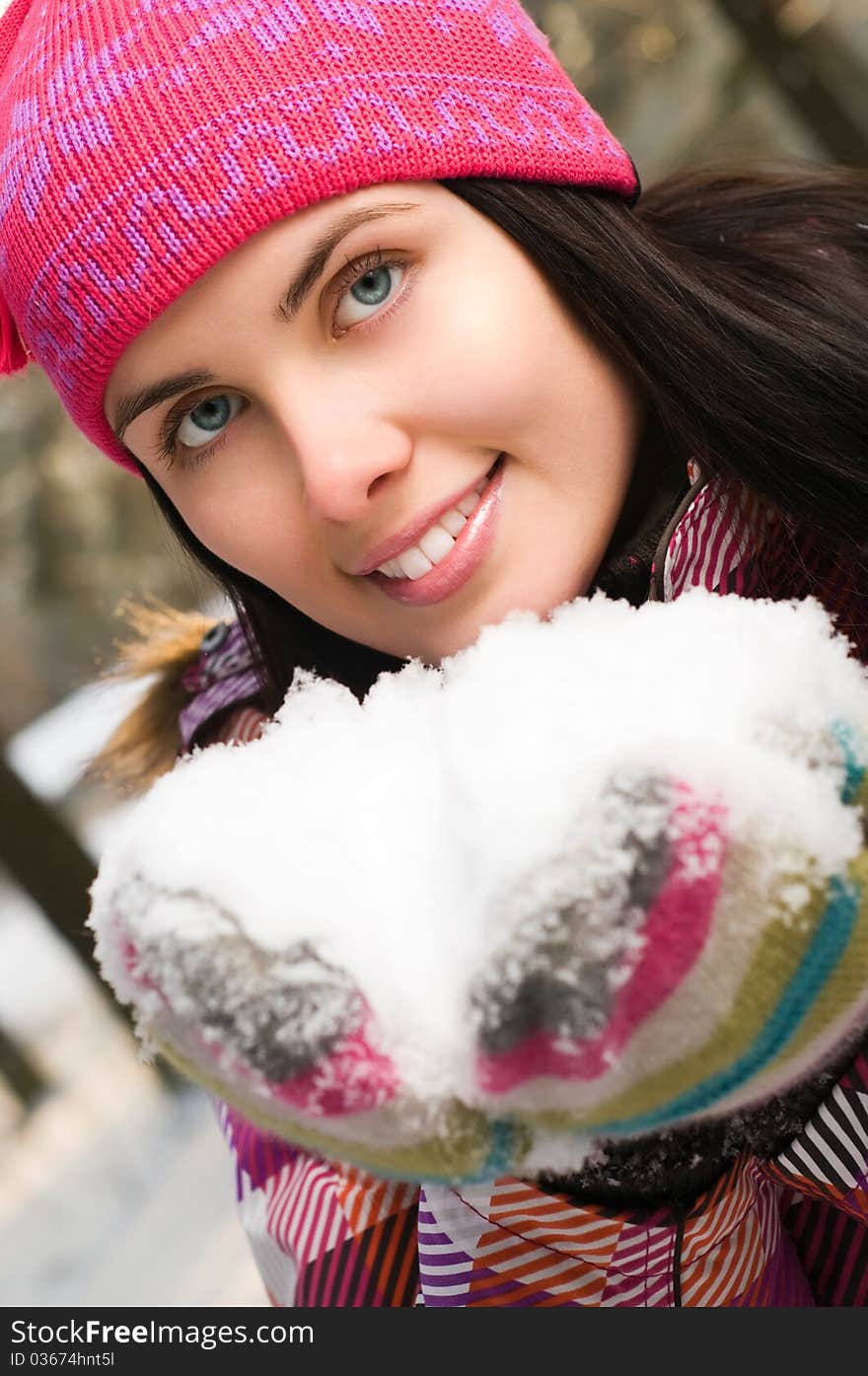 Beautiful young woman outdoor in winter with snow in her hands. Beautiful young woman outdoor in winter with snow in her hands