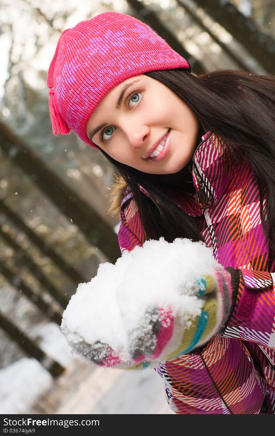 Beautiful young woman outdoor in winter with snow in her hands. Beautiful young woman outdoor in winter with snow in her hands