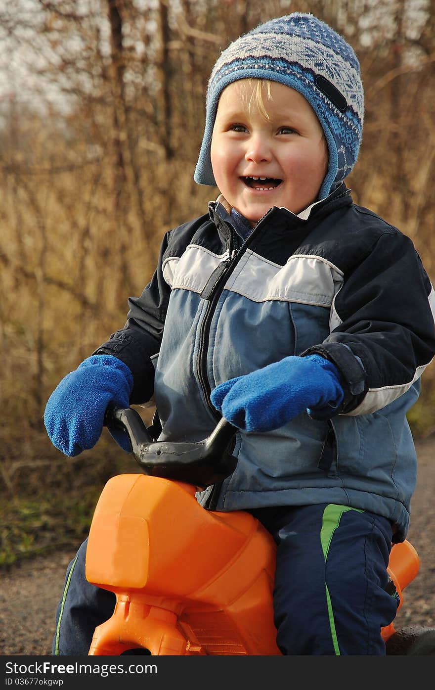 Smiling child sitting on motorbike