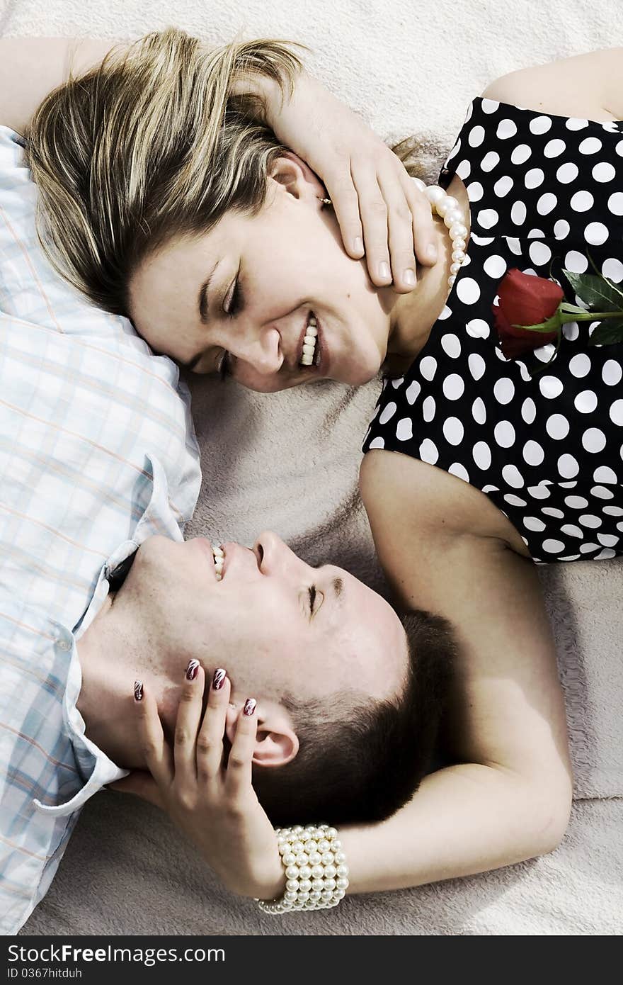 Couple with red rose lying on the blanket. Couple with red rose lying on the blanket