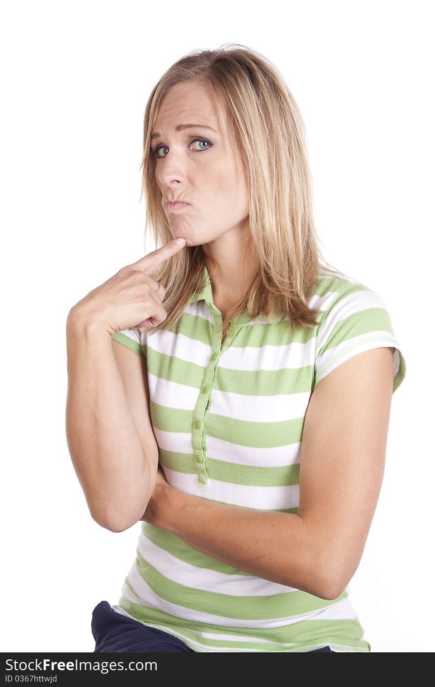 A woman in a green and white striped shirt making a face expression of deep thought. A woman in a green and white striped shirt making a face expression of deep thought.