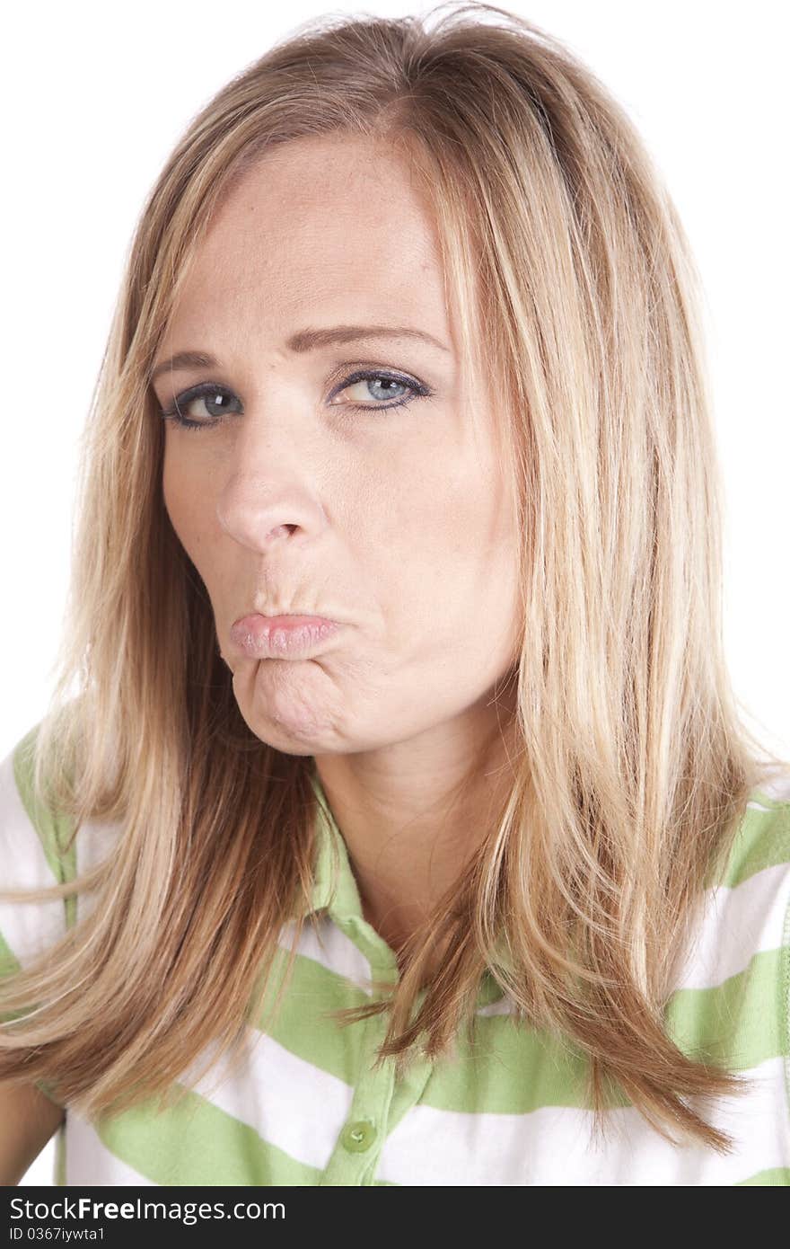 A woman in a green and white striped shirt making a face expression of sadness. A woman in a green and white striped shirt making a face expression of sadness.