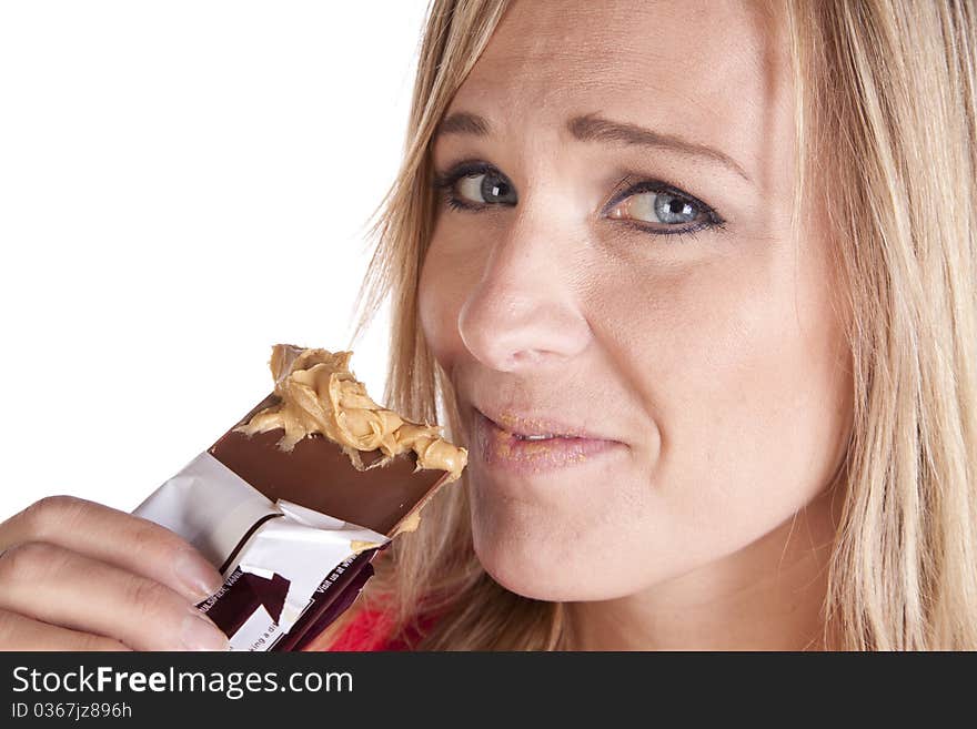 A woman up close with peanut butter on chocolate. A woman up close with peanut butter on chocolate.