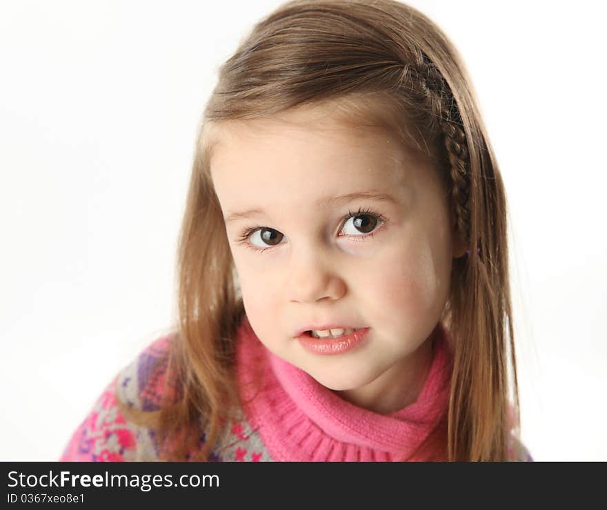 Portrait of a smilng adorable preschool girl wearing a knit pink dress and scarf. Portrait of a smilng adorable preschool girl wearing a knit pink dress and scarf