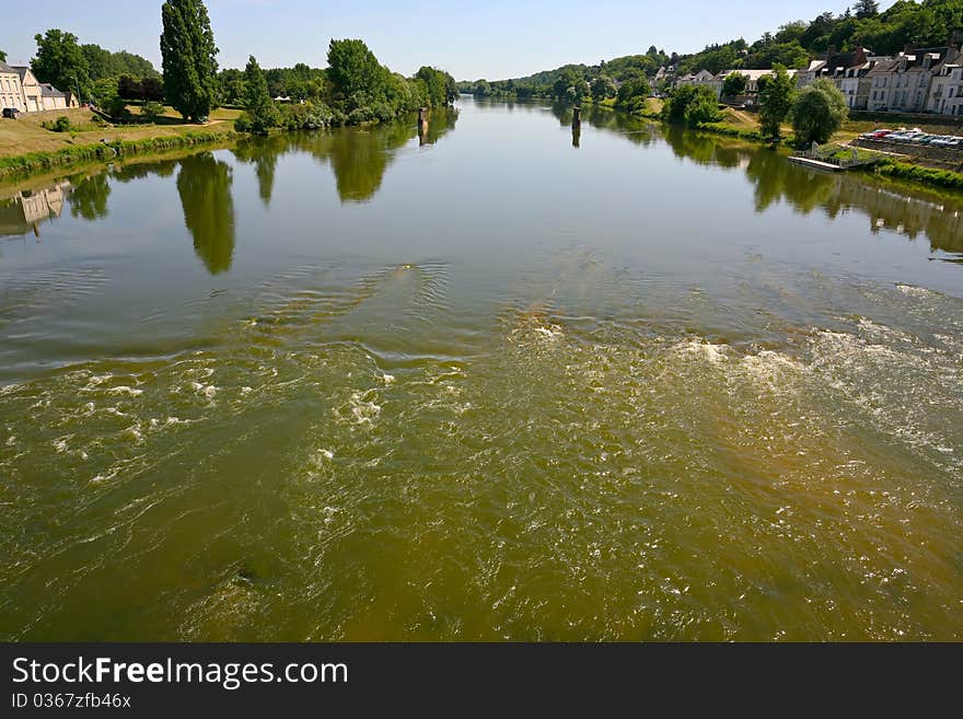 Wide, but not deep river in summer day