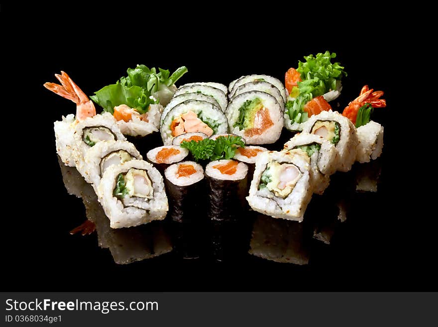 Japanese sushi seafood rolls with rice isolated on black