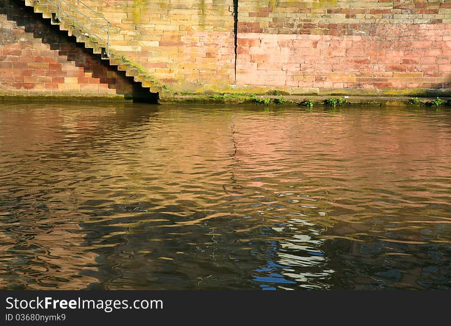 Steps on quay of canal of Ill river in old town. Steps on quay of canal of Ill river in old town