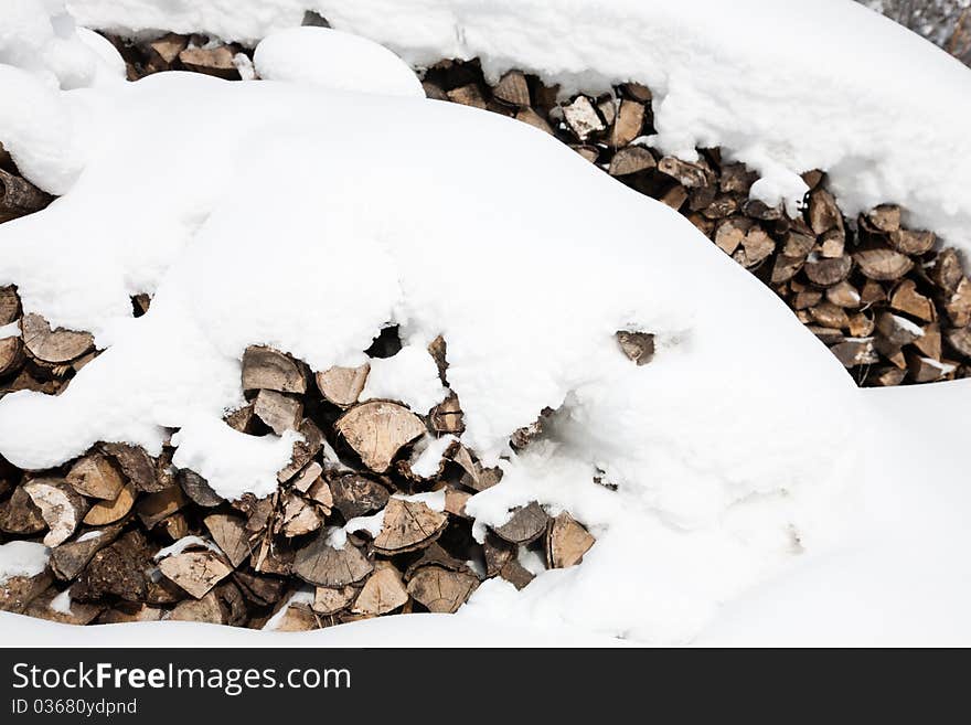 Stacks of firewood covered by snow. Stacks of firewood covered by snow