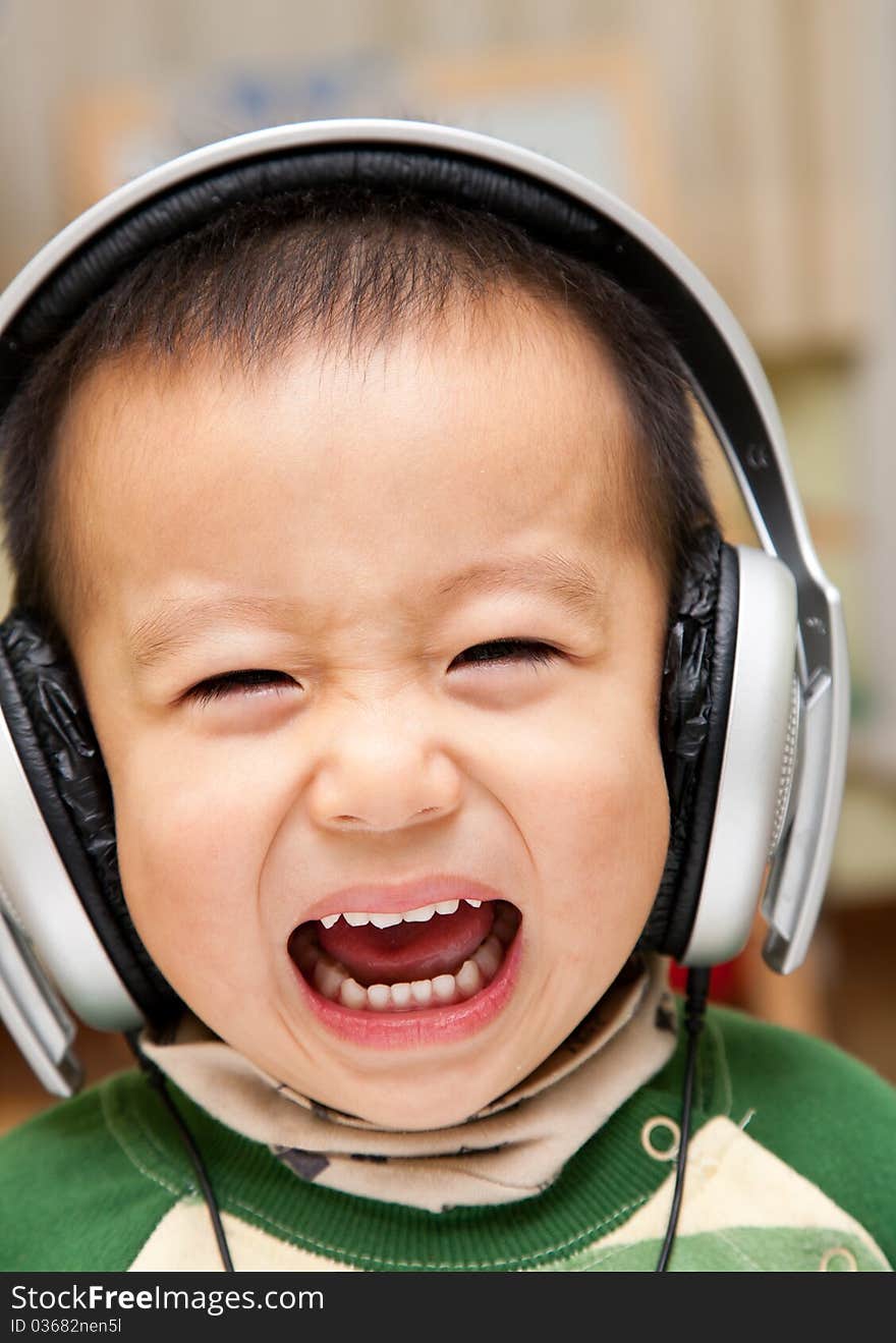 A boy enjoying music with a headphone. A boy enjoying music with a headphone