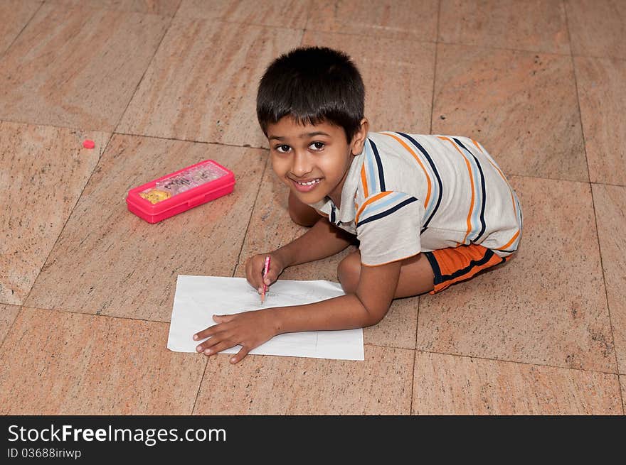 An handsome indian kid doing homework